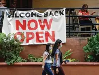  ?? Eric Gay / Associated Press ?? Visitors to the River Walk pass a restaurant that reopened in San Antonio last month.