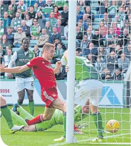  ??  ?? The Don’s Tommie Hoban scores after Hibs keeper Adam Bogdan’s howler