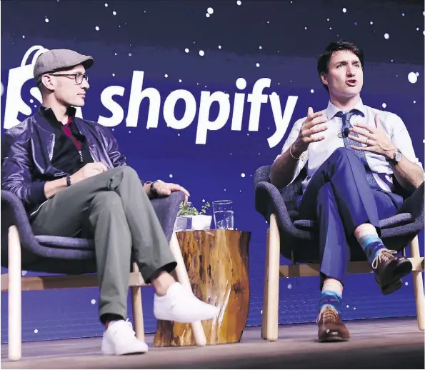  ?? THE CANADIAN PRESS/NATHAN DENETTE ORG XMIT: NSD505 ?? Prime Minister Justin Trudeau participat­es in an armchair discussion with Shopify CEO Tobias Lutke in Toronto on May 8. Spotify gets the vast majority of its revenue from outside of Canada.