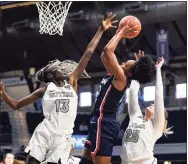  ?? Michael Conroy / Associated Press ?? UConn guard Christyn Williams, center, is fouled as she shoots by Butler forwards Ellen Ross (25) and forward Nyamer Diew, left, on Saturday.
