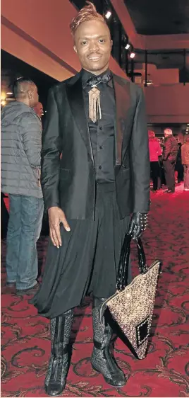  ?? PHOTO: JOHN HOGG ?? DASHING AND DARING: Choreograp­her Somizi Mhlongo looked good in his waistcoat, jacket and wide flowing pants that were cheekily paired with a studded glove and triangular bag