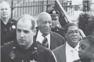  ?? THE ASSOCIATED PRESS ?? Bill Cosby, center, leaves hearings for jury selection in his sexual assault retrial Thursday with spokespers­on Andrew Wyatt, second right, at the Montgomery County Courthouse in Norristown, Pa.