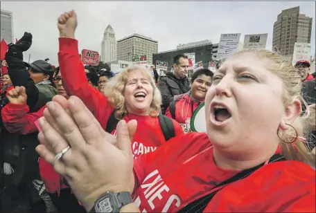  ?? Irfan Khan Los Angeles Times ?? RAIN FAILS to fizzle a downtown march at the California Charter Schools Assn. Hurdles remain for union and school officials to meet.