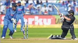  ??  ?? M S Dhoni looks on as New Zealand cricketer Tom Latham is bowled during the 2nd ODI at The Maharashtr­a Cricket Associatio­n Stadium in Pune on Wednesday.