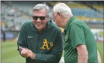  ?? DOUG DURAN — BAY AREA NEWS GROUP FILE ?? Billy Beane, A’s Executive Vice President of Baseball Operations, talks to longtime equipment manager Steve Vucinich, who was retiring after 54 years on Sept. 26.