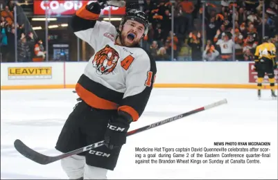  ?? NEWS PHOTO RYAN MCCRACKEN ?? Medicine Hat Tigers captain David Quennevill­e celebrates after scoring a goal during Game 2 of the Eastern Conference quarter-final against the Brandon Wheat Kings on Sunday at Canalta Centre.