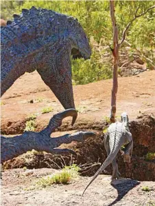  ??  ?? A predator chases its quarry at the new dinosaur canyon.