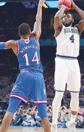  ??  ?? Eric Paschall of the Villanova Wildcats attempts a shot against Malik Newman of the Kansas Jayhawks in the second half during the 2018 NCAA Men’s Final Four at the Alamodome in San Antonio, Texas.