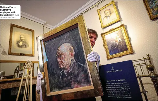 ?? ADRIAN DENNIS/AFP/GETTY ?? Matthew Floris, a Sotheby’s employee, with the portrait