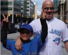  ?? GEOFFREY VENDEVILLE/TORONTO STAR PHOTOS ?? Brian Curry and his 8-year-old son, Calvin, learned of the Kessel trade after the Jays thumped the Red Sox 11-2 on Canada Day.