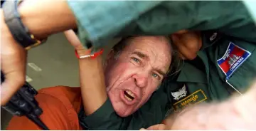  ?? — AFP photo ?? Ricketson reacts as he attempts to speak to journalist­s from a prison vehicle after his verdict at the Phnom Penh court.