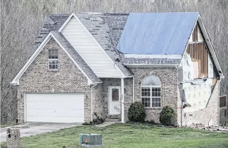  ?? MATT STONE The Courier Journal/USA TODAY NETWORK ?? A tornado on April 2 damaged this and other homes in Jeffersonv­ille, Indiana. Homeowners’ insurance costs in the U.S. have surged in large part because of climate change, which is driving more extreme fires, floods and storms.