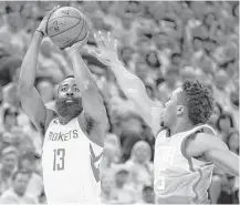  ?? Michael Ciaglo / Houston Chronicle ?? Rockets guard James Harden shoots over Jazz guard Donovan Mitchell during the first half of Game 3. Harden had 25 points.