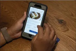  ?? JACQUELYN MARTIN — THE ASSOCIATED PRESS ?? A diner at Bartaco uses their app to order an item off the menu, at the restaurant in Arlington, Va. The restaurant is using an automated app for ordering and payments. Instead of servers they use “food runners” to get the food to the tables.