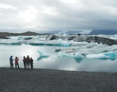  ??  ?? The author’s family looks out over a glacial lagoon in southern Iceland.