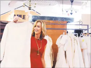  ?? Hearst Connecticu­t Media file photo ?? Greenwich resident Lara Spencer looks at wedding gowns at the Greenwich Hospital Auxiliary Thrift Shop in 2012 for a segment on thrift stores on ‘Good Morning America.’