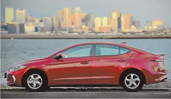  ?? STAFF PHOTOS BY JIM MAHONEY ?? ECO, SUAVE: Features of the 2017 Hyundai Elantra ECO, above, include a leatherwra­pped steering wheel, far left, a two-tone interior, and contrastin­g fabric seats. The infotainme­nt system features a 7-inch touch screen and Bluelink.