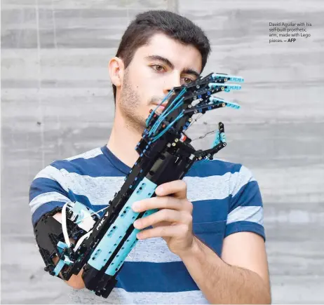  ?? — AFP ?? David Aguilar with his self-built prosthetic arm, made with Lego pieces.