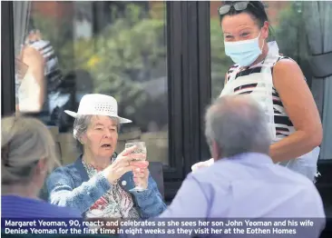  ??  ?? Margaret Yeoman, 90, reacts and celebrates as she sees her son John Yeoman and his wife Denise Yeoman for the first time in eight weeks as they visit her at the Eothen Homes