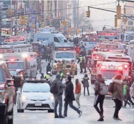  ??  ?? Eighth Avenue in Manhattan is filled with police and fire department equipment and personnel after an explosion in a subway passageway. SETH HARRISON/THE JOURNAL NEWS VIA USA TODAY NETWORK