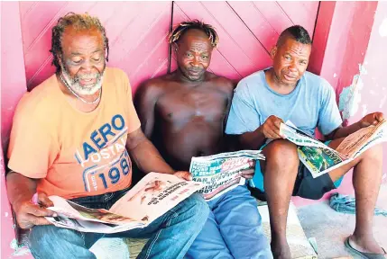  ?? PHOTO BY LEON JACKSON ?? From left: Keith Brown, Ewan Kenton, and Joash Melbourne, fishermen from Duncans, Trelawny, read their copies of the WESTERN STAR.