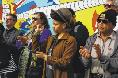  ?? Photos by Gabrielle Lurie / The Chronicle ?? Melorra Green (center) and other Galería de la Raza supporters react at a news conference at the gallery.