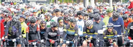  ??  ?? Thousands of cyclists in Cardiff await to be called through to the starting line for the Velothon