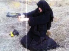  ??  ?? Hayat Boumeddien­e, above, who was married to Amedy Coulibaly, left, in an Islamic ceremony, wields a weapon in a French forest in an image posted on Twitter.