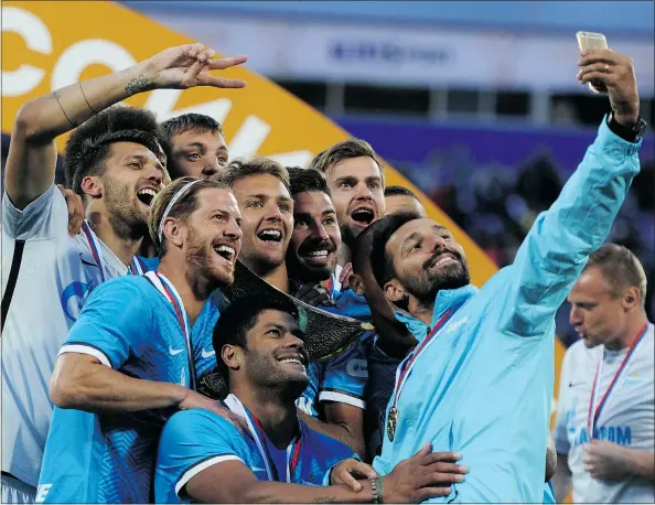 ?? — GETTY IMAGES FILES ?? Zenit St. Petersburg players, including Brazilian striker Hulk (bottom left), celebrate after winning their Russian Super Cup match on July 12. Hulk has repeatedly faced monkey chants in Russia and also accused a referee of racially abusing him.