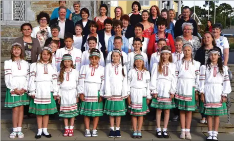  ??  ?? Children from Chernobyl with members of their host families The Friends of the Children of Chernobyl Rathmore Branch at the 21st Anniversar­y Mass in Rathmore Church on Wednesday. Photo by Michelle Cooper Galvin