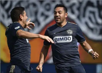  ?? DERIK HAMILTON — THE ASSOCIATED PRESS ?? The Union’s Marco Fabian, right, celebrates with Alejandro Bedoya after scoring a goal against Orlando City July 7 in Chester.