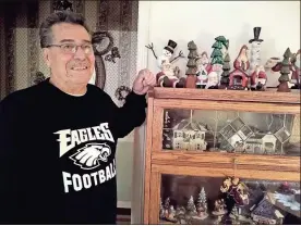  ?? / Michelle Wilson ?? Frank Curti stands with some of his handcrafte­d wooden Christmas decoration­s at his house. Many of these were inspired by decoration­s his wife has seen in stores that sell for sometimes more than $100. Curti encourages her to take a photo of the items she likes and he makes his own creations for her.