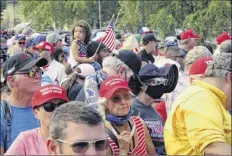  ?? Scott Sonner / Associated Press ?? People line up outside the gates three hours before President donald trump is scheduled to speak Saturday night at a campaign rally at minden-tahoe Airport under smoky skies from California wildfires along the Sierra nevada’s eastern front in minden, nev., on Saturday.