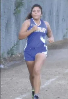  ?? PHOTO AARON BODUS ?? Jaasiel Contreras, of Brawley, doing what she does. Contreras’s first-place finish in the girls’ varsity race was her second consecutiv­e win and third of the season.