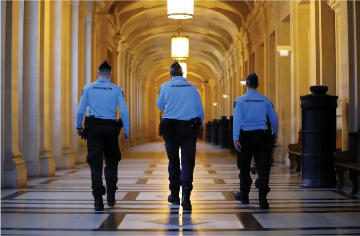  ?? (Reuters) ?? FRENCH GENDARMES walk in the corridors of a Paris courthouse before the verdict in the trial of Abdelkader Merah, brother of gunman Islamist militant Mohammed Merah, who killed 7 people in 2012.