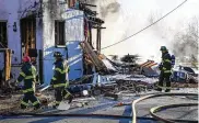  ?? JERRY JACKSON / BALTIMORE SUN ?? Baltimore firefighte­rs at the scene of an explosion in Baltimore’s Pigtown neighborho­od on Tuesday. Three people were injured.