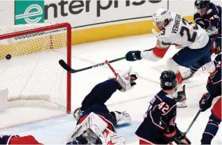  ?? PAUL VERNON THE ASSOCIATED PRESS FILE PHOTO ?? One-time Niagara Icedogs captain Carter Verhaeghe, now with the National Hockey League’s Florida Panthers, scores a goal on Blue Jackets goalie Elvis Merzlikins on Jan. 28 in Columbus.
