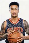  ?? GETTY IMAGES ?? Rookie John Collins models a new Hawks jersey, which has a Sharecare logo on the player’s left shoulder.