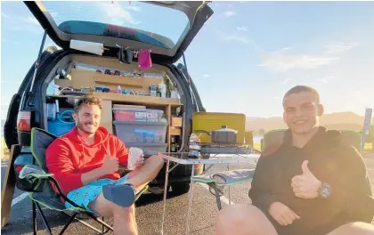  ?? Photo / Alison Smith ?? Christian Munz and Marvin Haeger enjoying some alone time freedom camping in Tairua.