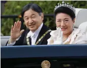  ?? — AFP ?? Japan’s Emperor Naruhito (left) and Empress Masako wave during a royal parade in Tokyo on Sunday.