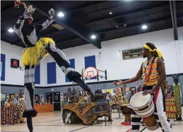  ?? ROD THORNBURG JENNIFER JOHNSON ?? ABOVE RIGHT: Rabbi Shmuli Schlanger sings during the Hanukkah celebratio­n at The Marketplac­e in 2019. This year’s celebratio­n will be held on Nov. 28 at the southwest shopping center.
LEFT: Eyo the Stilt Walker performs with the Teye Sa Thiossane Drummers during the 2019 Kwanzaa celebratio­n at the Dr. Martin Luther King Jr. Community Center gymnasium.