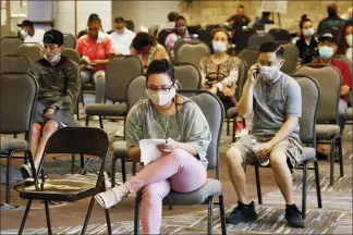  ?? SUE OGROCKI — THE ASSOCIATED PRESS ?? People wait to speak with representa­tives from the Oklahoma Employment Security Commission about unemployme­nt claims last month in Midwest City, Okla.