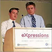  ?? SUBMITTED ?? Notre Dame-Cathedral Latin’s Augie King and Zach Urda, both Class of 2019, present their Best-in-Show math project during the award ceremony of the Cleveland Clinic’s eXpression­s Program at the Global Center for Health Innovation.