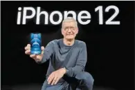  ?? (AFP) ?? Apple CEO Tim Cook holds up the all-new iPhone 12 Pro during an Apple event at Apple Park in Cupertino, California on Tuesday.