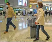  ?? (AFP) ?? Passengers wearing face masks are seen at Shanghai Hongqiao Internatio­nal Airport in Shanghai, China on Friday