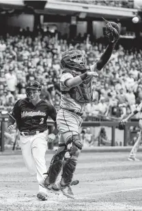  ?? Morry Gash / Associated Press ?? The Brewers' Trent Grisham scores past Rangers catcher Jose Trevino during the fourth inning Saturday in Milwaukee.