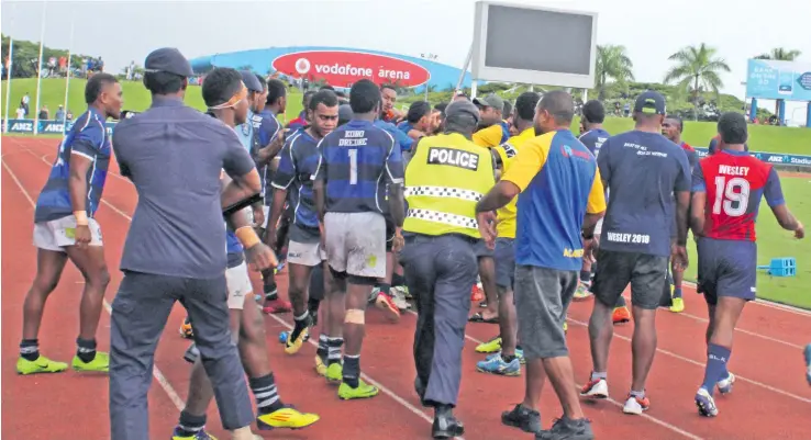  ?? Photo: Simione Haravanua ?? Police rush in to stop the brawl between Lelean Memorial School and John Wesley College players during the Vodafone Fiji Secondary Schools Rugby League Under-19 semifinal at the ANZ Stadium, Suva on April 7, 2018.
