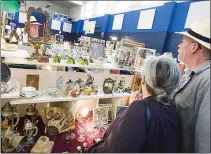  ?? STAFF FILE PHOTO ?? Shoppers browse through the antiques at the St. Christophe­r Ladies Guild Antique Show. This year’s event, which will be held Jan. 25-27, includes a minirestau­rant, night club, children’s crafts, baked goods and a silent auction.