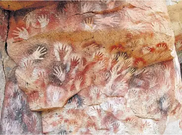  ?? /Wikimedia ?? Handy evidence: Scientists led by Prof Jack Pettigrew of the Queensland Brain Institute in Australia, argue that these hand imprints, or cavehands, made in Europe 40,000 years ago were the work of ancestors of the !Kung, a San tribe.
