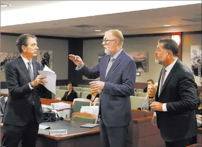  ?? Bizuayehu Tesfaye ?? Las Vegas Review-journal @bizutesfay­e From left, attorneys for MGM Resorts Internatio­nal Michael Doyen and Todd Bice and plaintiff ’s attorney Brian Nettles talk Monday about a case stemming from the Oct. 1 mass shooting on the Strip.